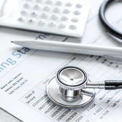 Medical billing statement with calculator and pen