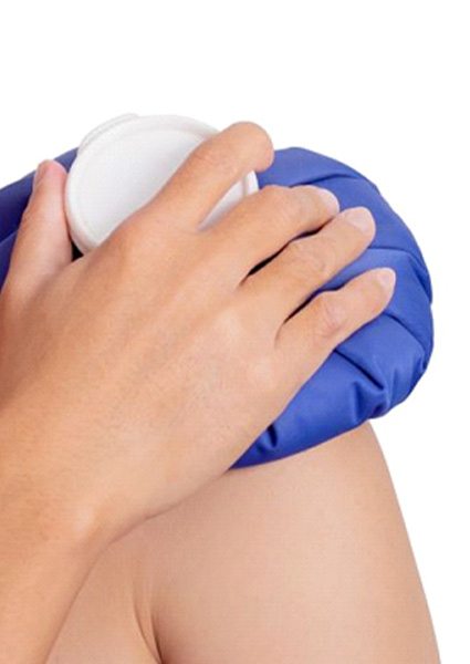 Person applying ice pack to their shoulder