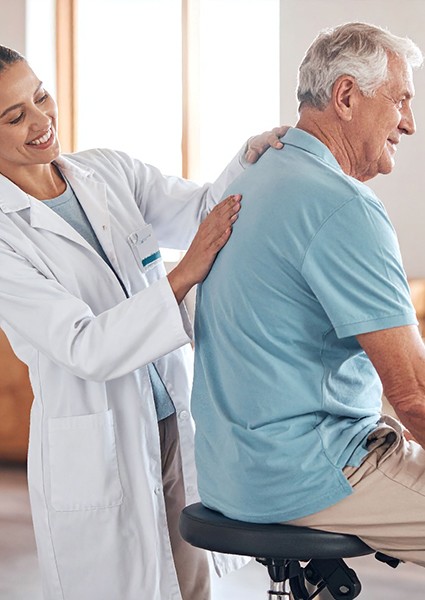 Orthopedic doctor examining patient’s back