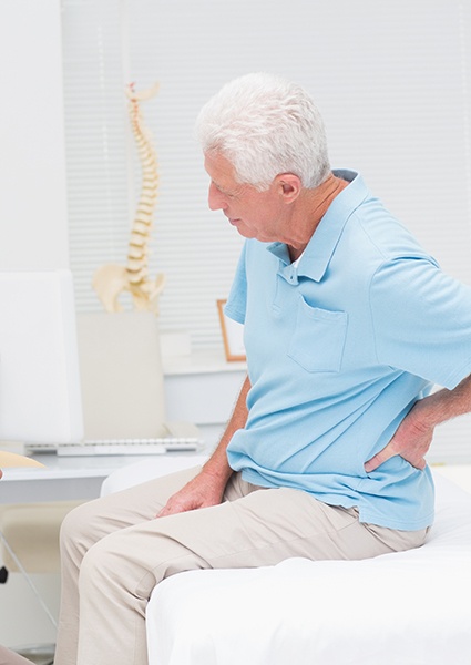 Patient discussing back pain with doctor
