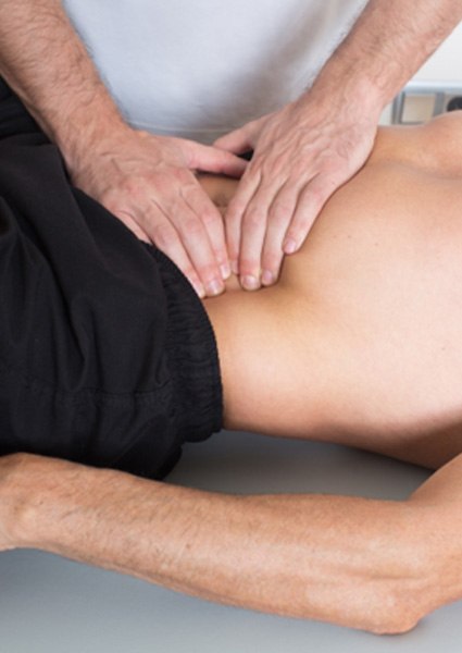 Man sitting at desk, suffering from back pain