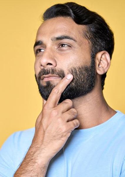 Handsome man with thoughtful, curious expression on his face