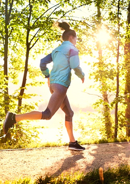 woman jogging on nature trail