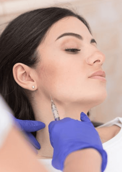 Patient receiving BOTOX injection near her TMJ
